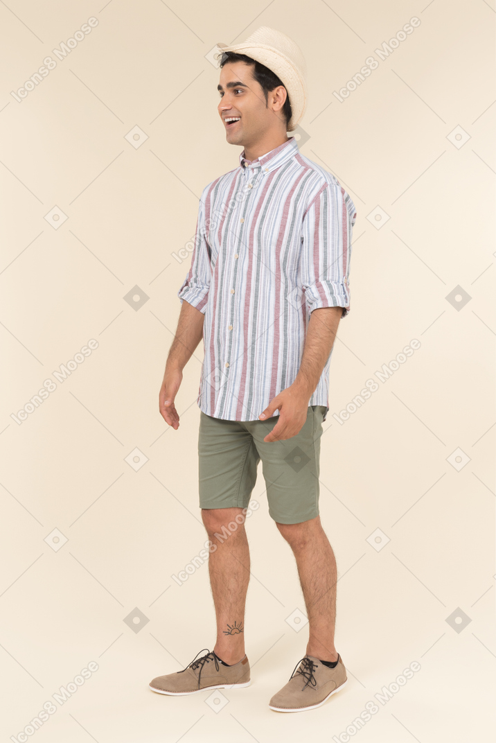 Surprised young caucasian guy holding his one hand in the pocket
