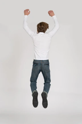 Young man in casual clothes jumping