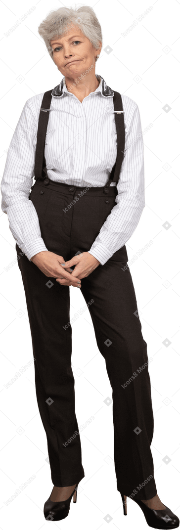 Front view of a displeased old lady in office clothing putting hands together
