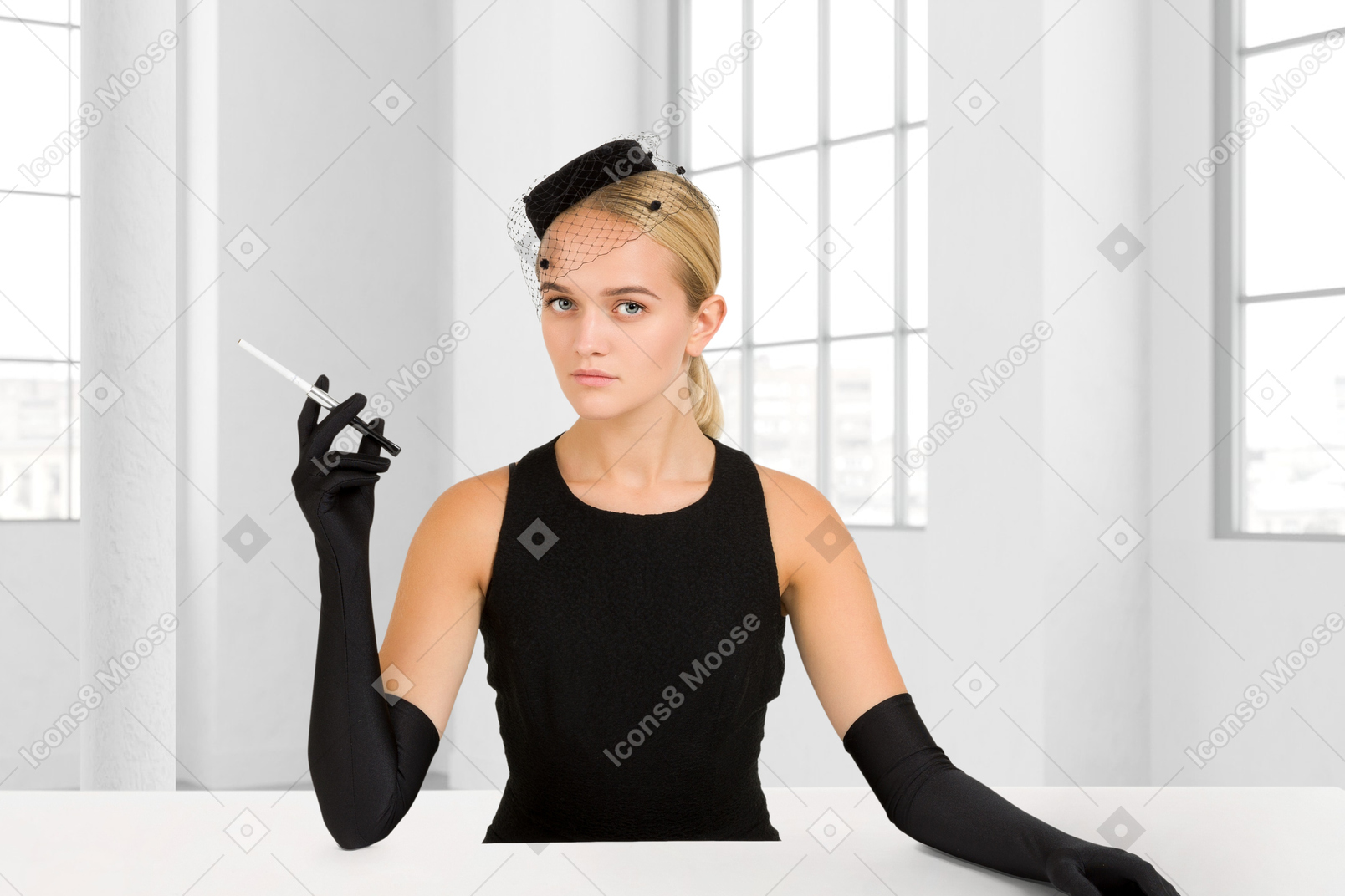 A woman sitting at a table with a cigarette in her hand