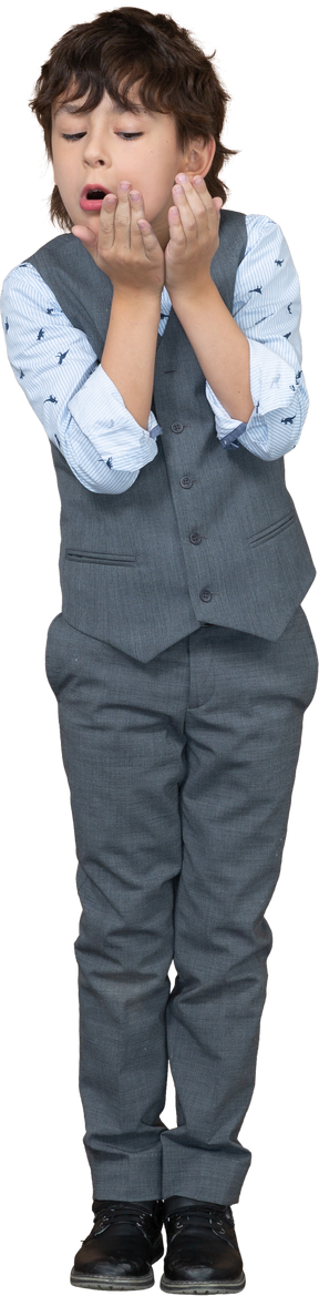 Front view of a boy in grey suit blowing a kiss