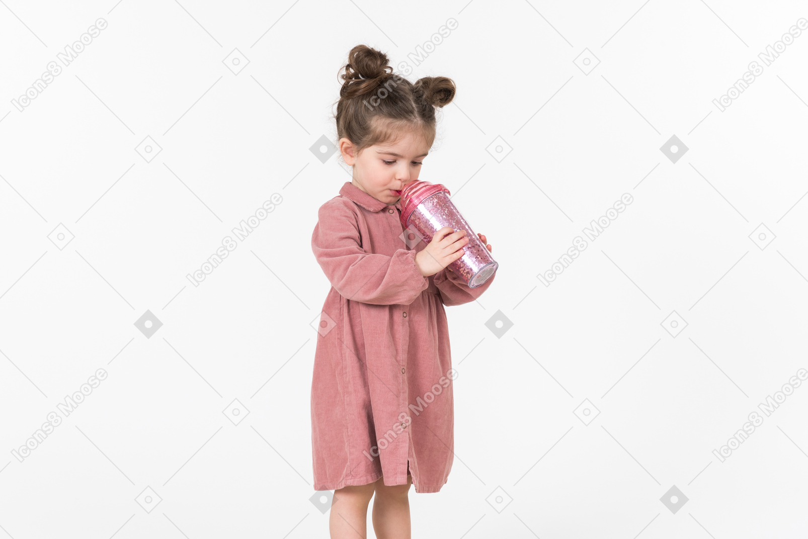 Little kid girl drinking from the pink plastic cup