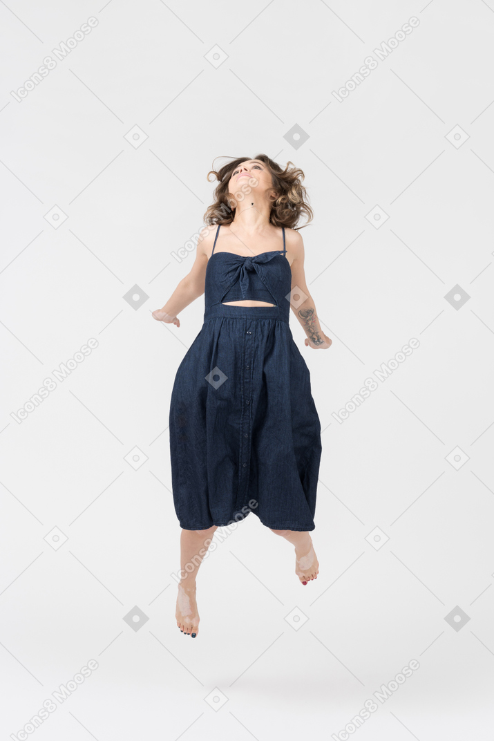 Young woman jumping up high