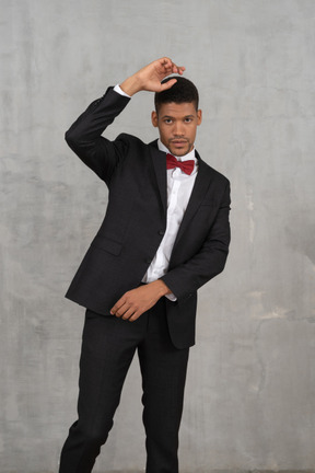 Man in black suit posing