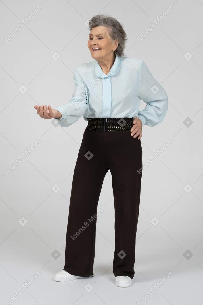 Old woman stretching out hand with a smile