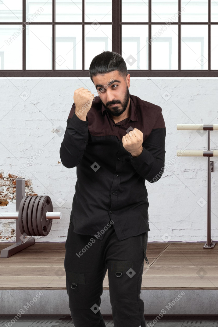 Man in black shirt and pants trying to box