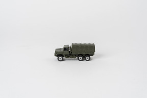 A toy army truck standing alone against a plain white background