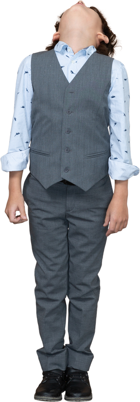Front view of a boy in grey suit looking up