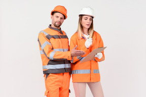 Female and male workers looking at something in the file