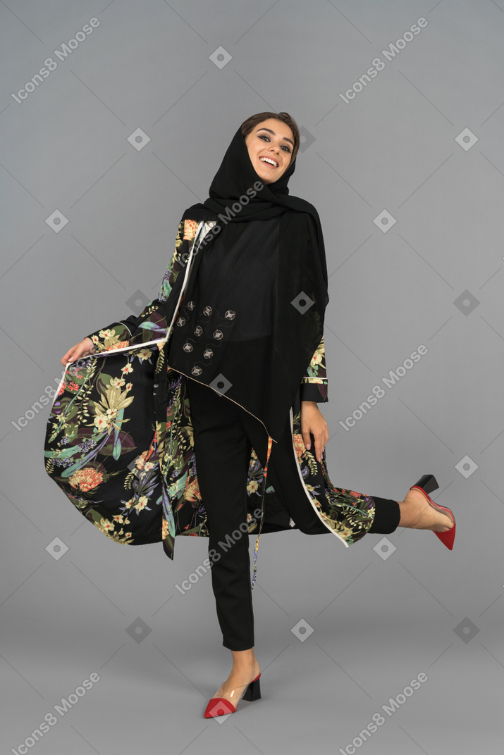 Cheerful middle eastern woman dancing