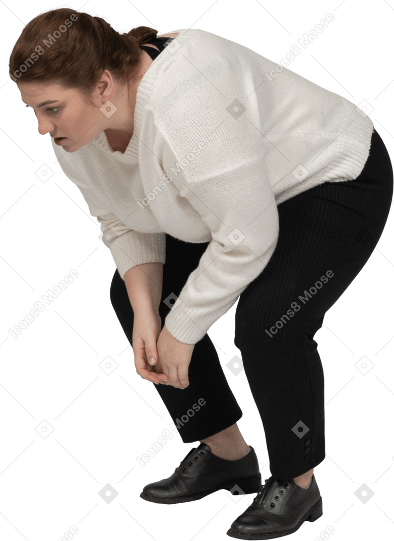 Side view of a plump woman in casual clothes bending down