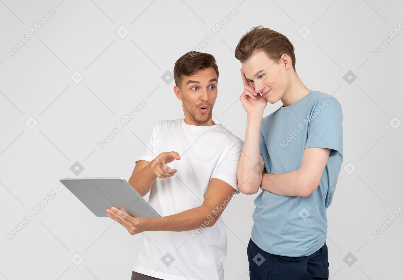 Brothers looking at tablet and discussing it