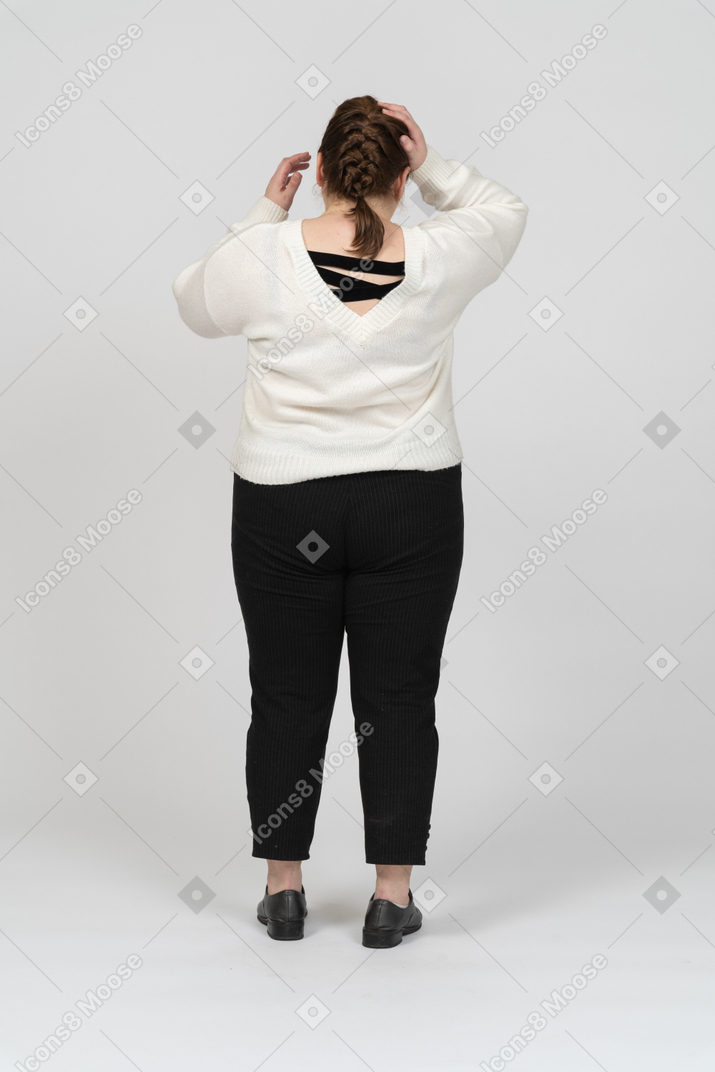Plump woman in casual clothes touching her head