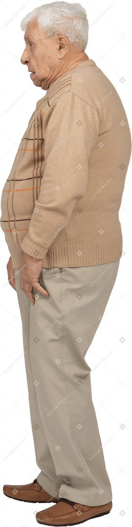 Side view of an impressed old man in casual clothes