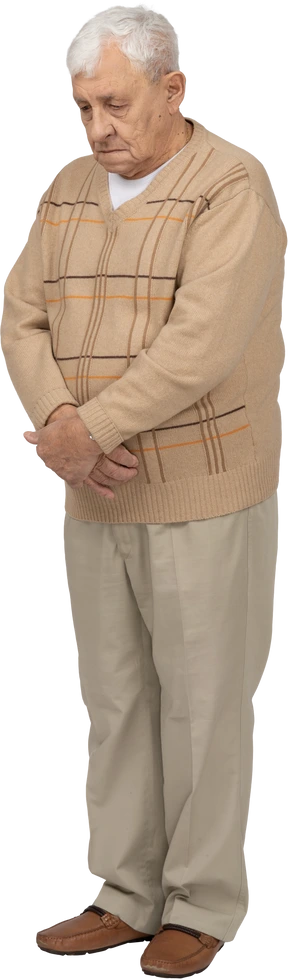 Front view of an old man in casual clothes looking down