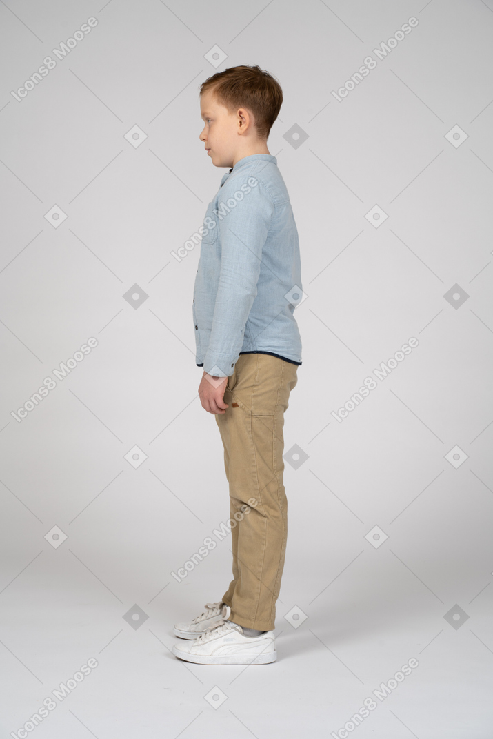 Cute boy standing in profile