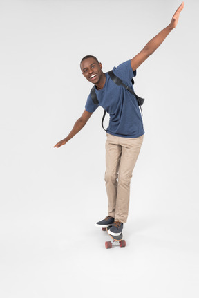 Male tourist standing half sideways back to camera on skateboard