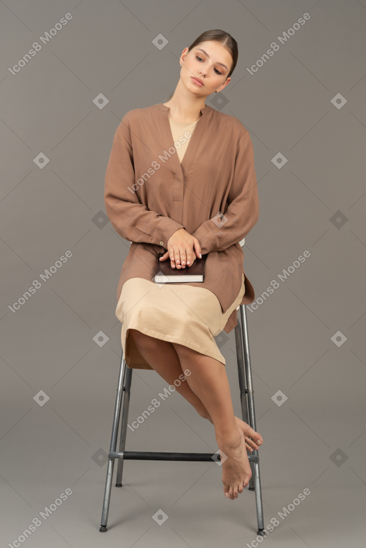 Young woman sitting with her head tilted