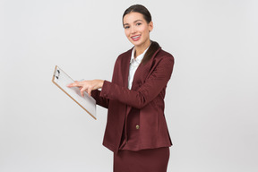 Attractive formally dressed woman checking notes