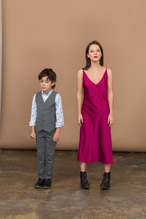 Front view of a boy in suit vest and young woman