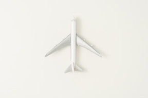 Toy airplane on grey background