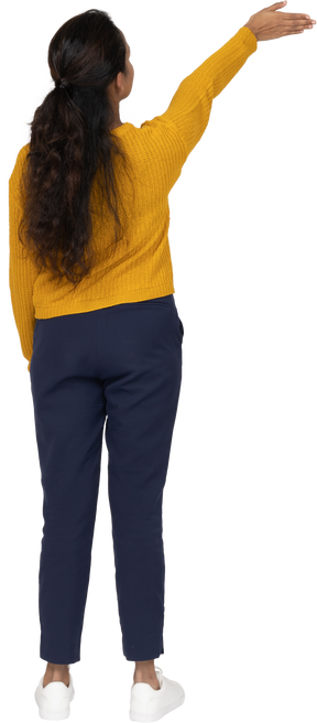 Rear view of a girl in casual clothes showing direction
