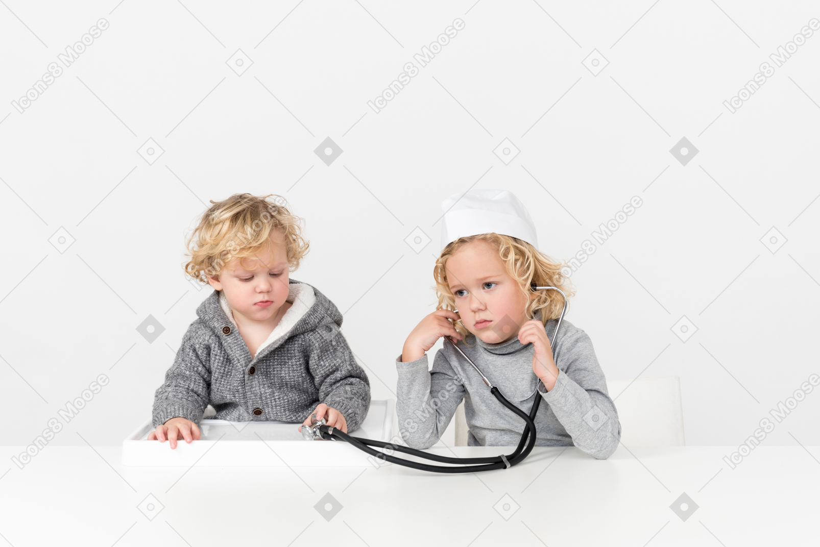Brothers playing doctor with stethoscope