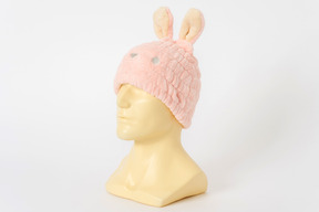 Pink bunny hat on a mannequin head