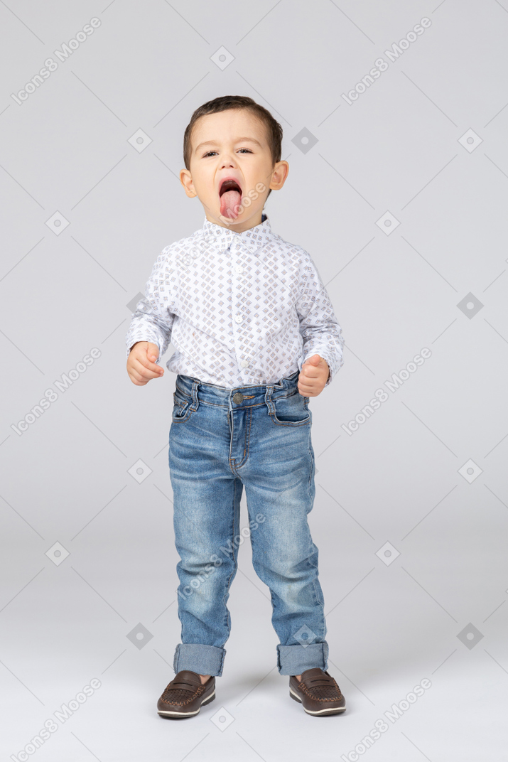 Cute little boy showing his tongue