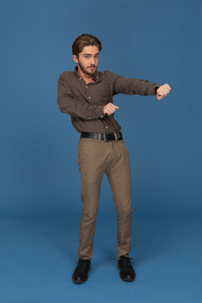 A dancing slim young man looks to camera