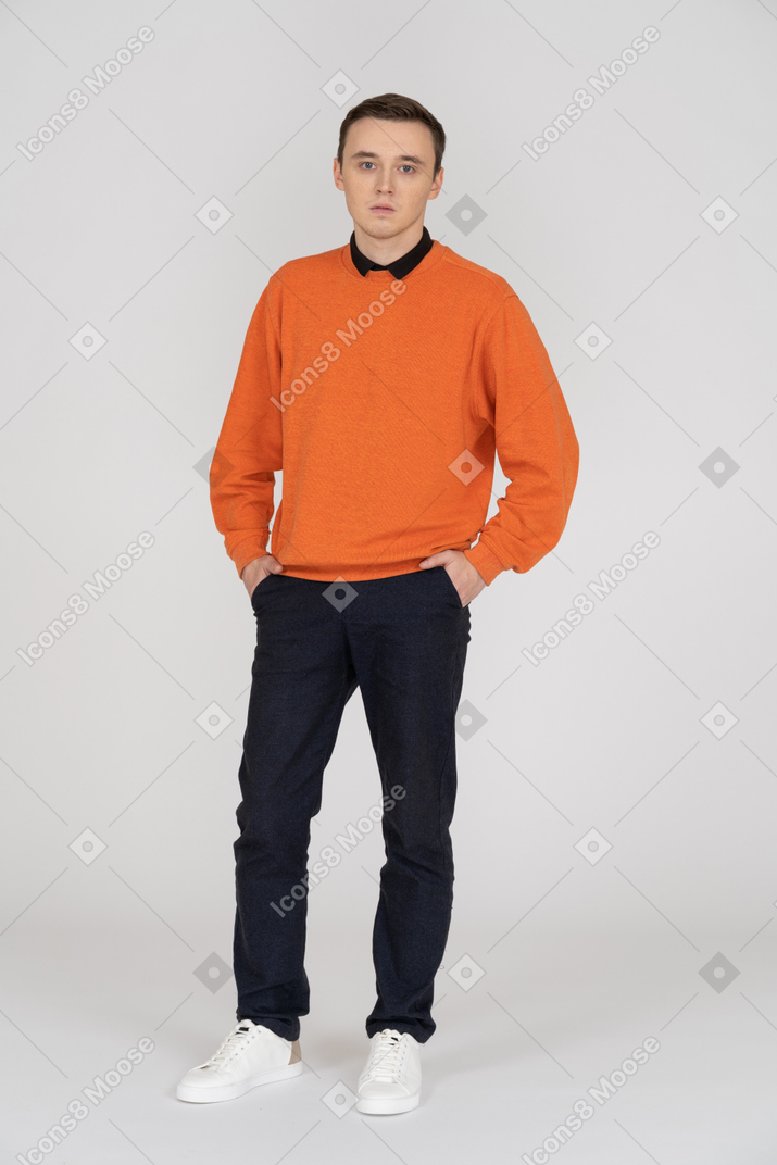 Young man in orange sweatshirt standing