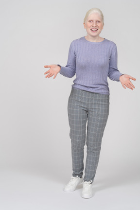 Young woman spreading arms and looking at camera