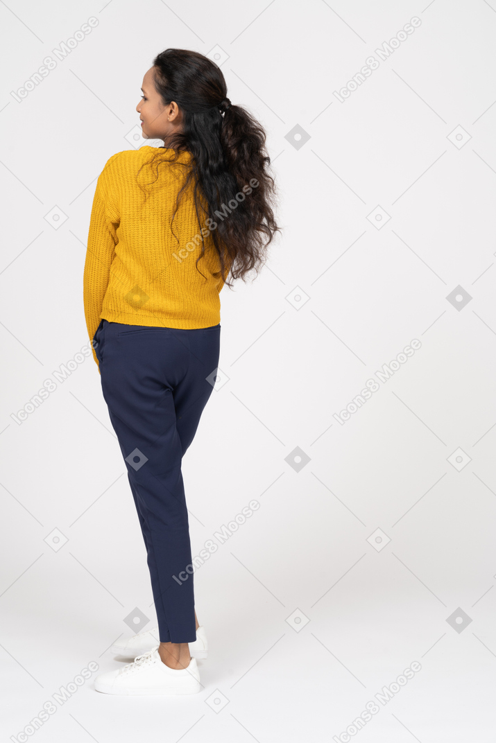 Back view of a cute girl in casual clothes