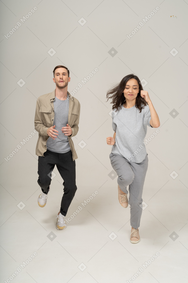 Front view of man and woman running toward the camera