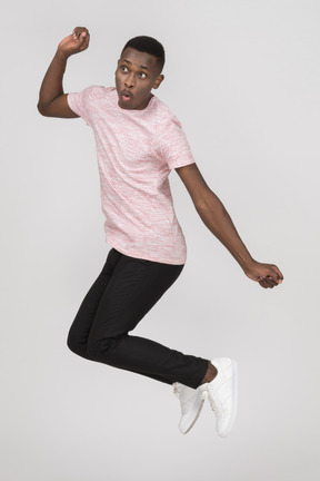 Young man jumping and looking away
