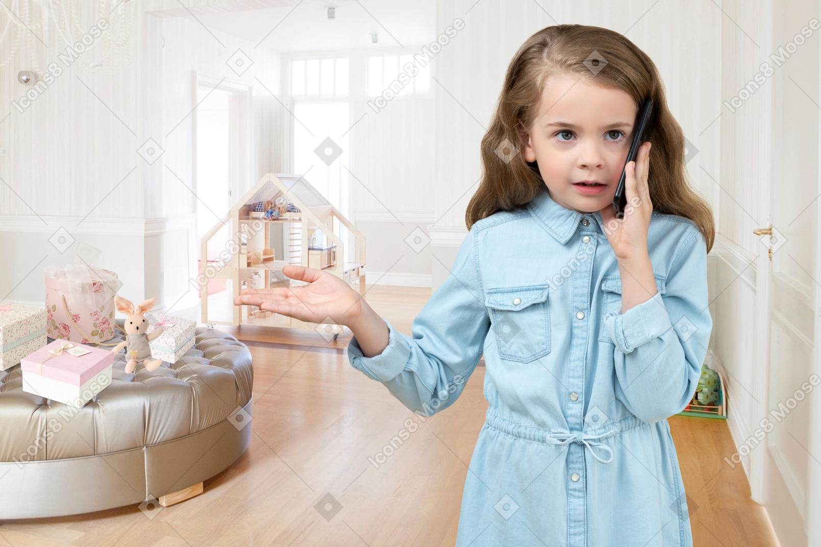 A little girl holding a cell phone to her ear