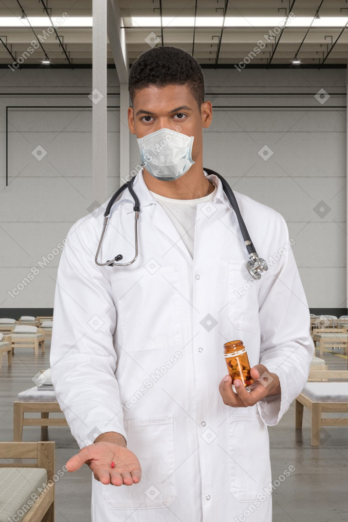 A man in a white lab coat holding a bottle of medicine