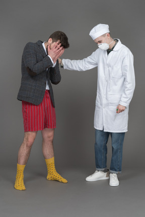 Doctor and young man mourning someone