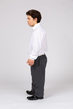 Side view of an office worker standing with eyes closed