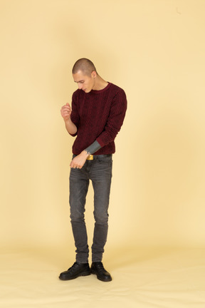 Front view of a tired dancing young man in red pullover