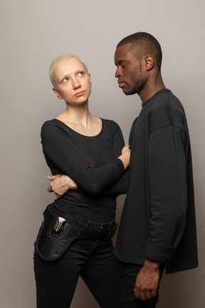 Young woman standing with a man and looking up