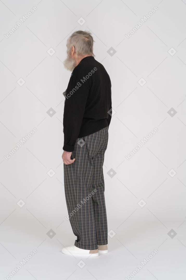 Three quarter back view of an old man standing