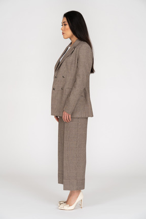 Side view of a young lady in brown business suit