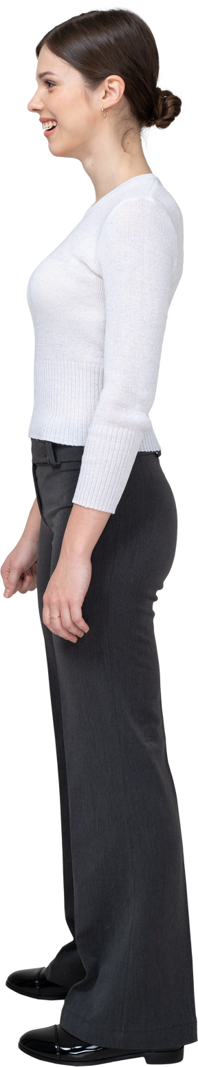 Side view of a confused smiling young woman in office clothing