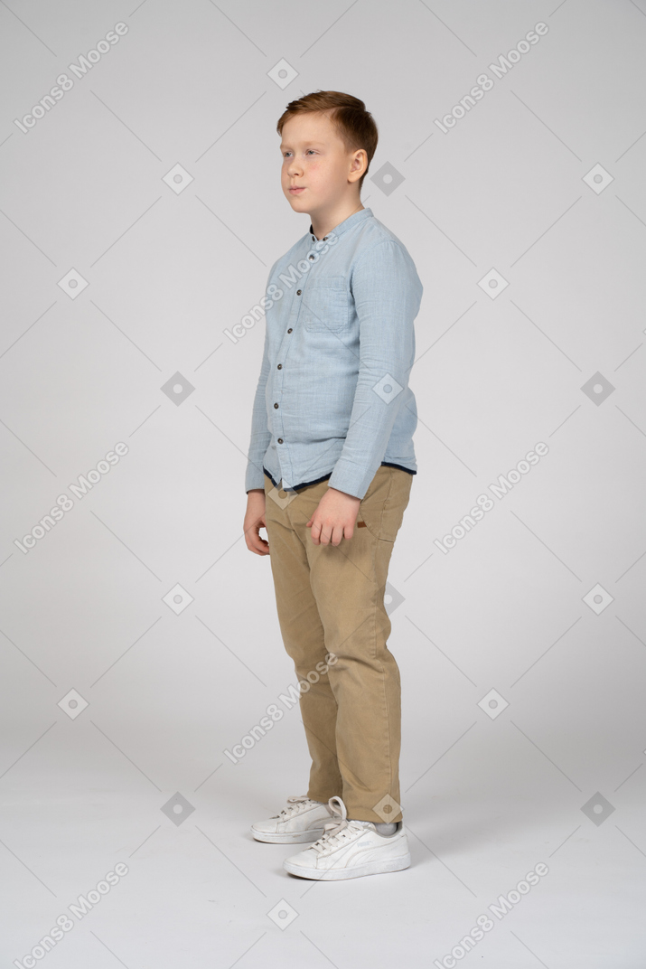 Cute boy standing in profile