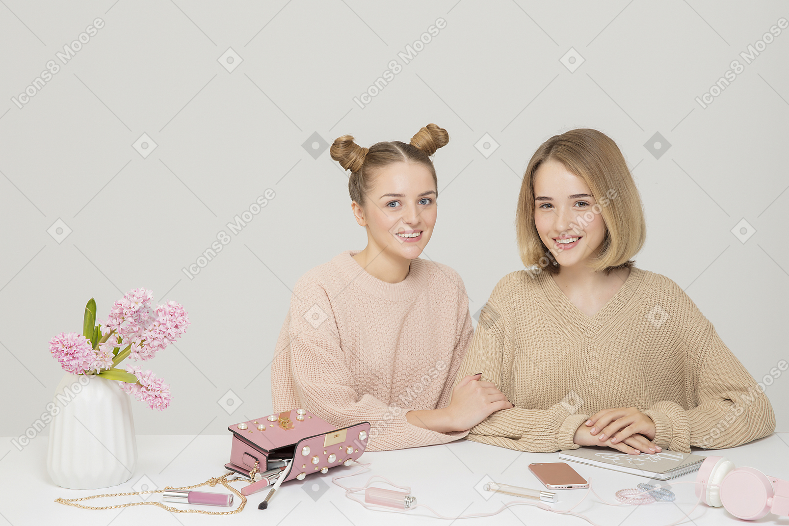 Two friends sitting at the disoraganized table