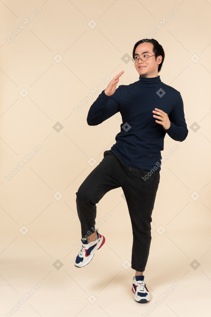 Young asian man trying to do karate