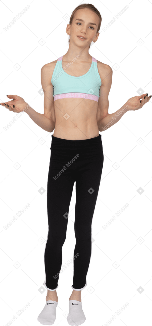 Front view of a teen girl in sportswear raising hands and looking straight