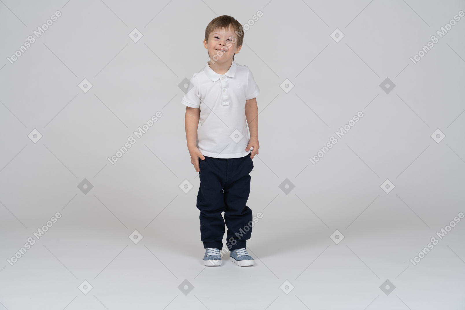 Front view of joyful little boy standing upright