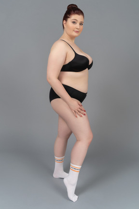 Plump caucasian female posing in black lingerie